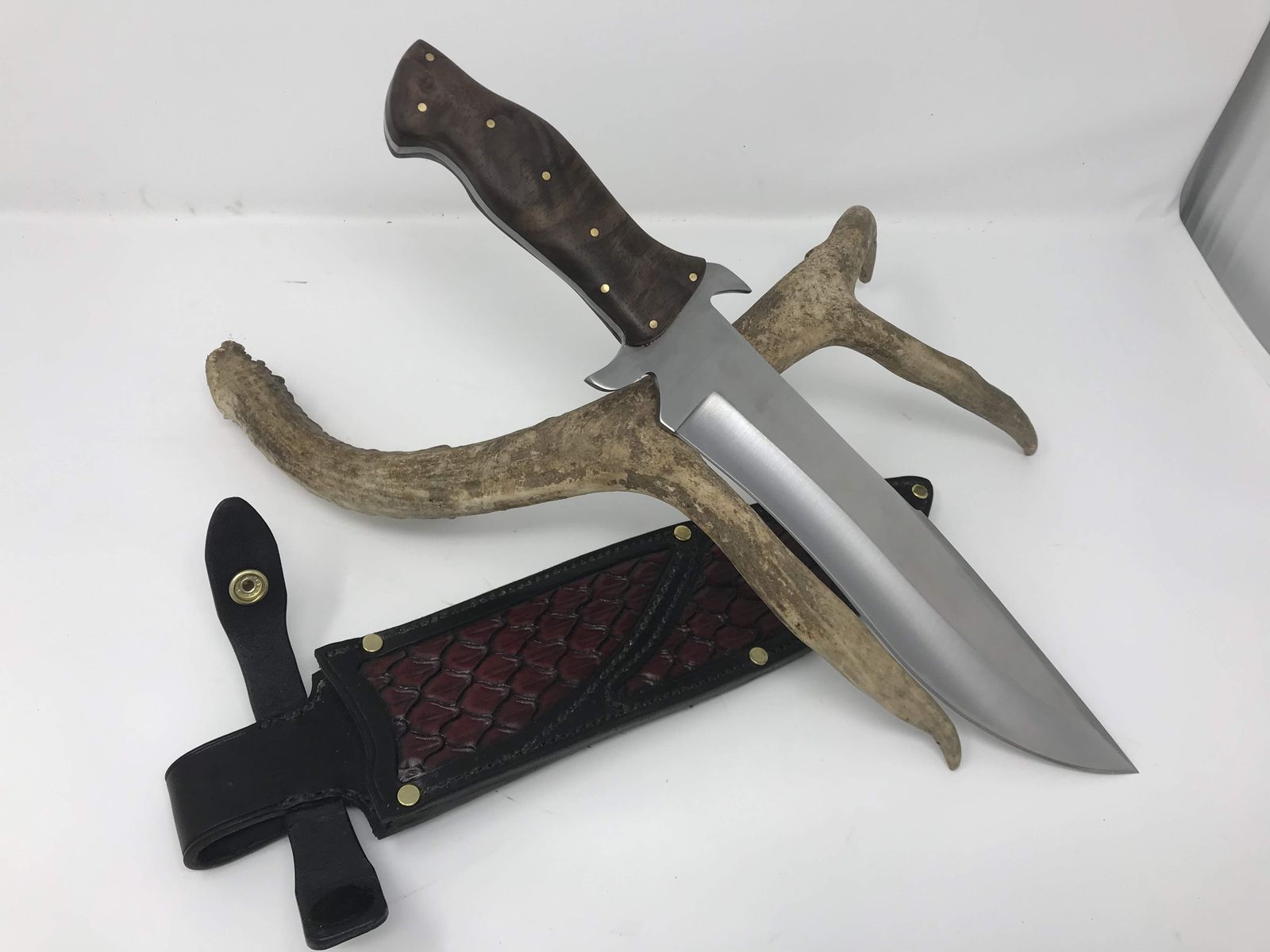 Bowie knife with tooled leather sheath and antler